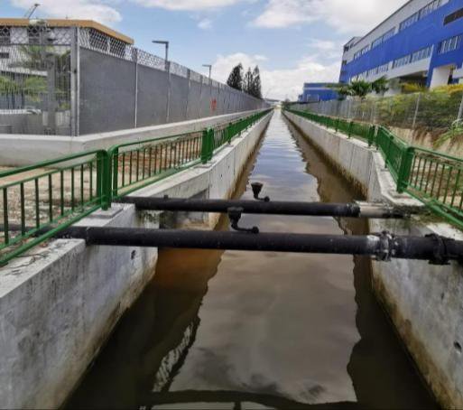Completed roadside box drain with new safety railings and HDPE service pipes
